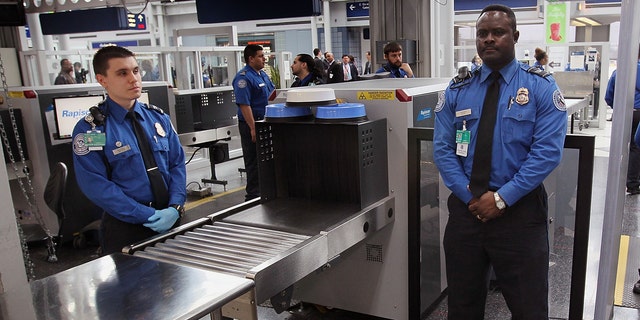 Transportation Security Administration (TSA) officers staff a checkpoint at O'Hare International Airport
