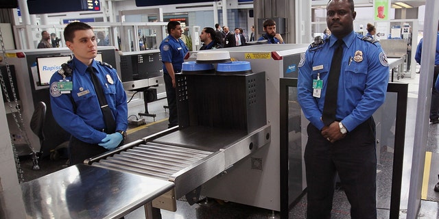 Transportation Security Administration (TSA) officers staff a checkpoint at O'Hare International Airport