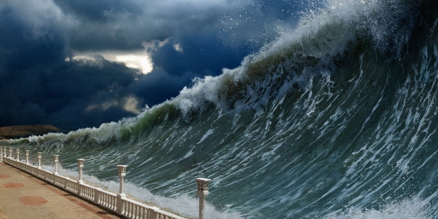 Apocalyptic dramatic background - giant tsunami waves, dark stormy sky (Ig0rZh) (Credit: iStock)