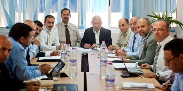Oct. 27, 2011: Tunisian leader and founder of the moderate islamist party Ennahda, Rached Ghannouchi, center right, chairs an executive board at the party's headquarters in Tunis.