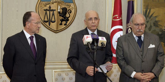 Jan. 14: Prime Minister of Tunisia, Mohammed Ghannouchi, center, before he addressed the nation to announce that he is assuming power in Tunisia.