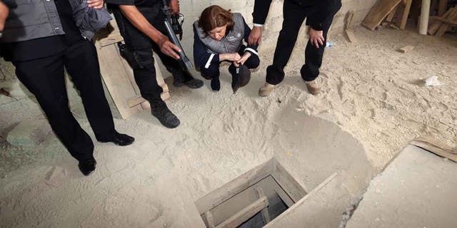 Authorities inspect the exit of the tunnel used by Joaquin "El Chapo" Guzman on Sunday, July 12, 2015.