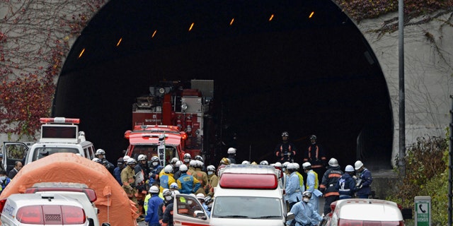 Dec. 2, 2012: Police officers and firefighters gather at the exit of the Sasago Tunnel on the Chuo Expressway in Otsuki, Yamanashi Prefecture, central Japan.