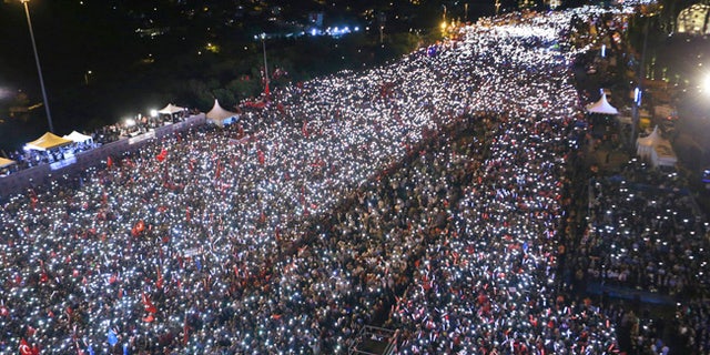 An aerial view of the ceremony to commemorate the one year anniversary of the July 15, 2016 failed coup attempt, in Istanbul, Saturday, July 15, 2017. Turkey commemorates the first anniversary of the July 15 failed military attempt to overthrow Turkey's President Recep Tayyip Erdogan, with a series of events honouring some 250 people, who were killed across Turkey while trying to oppose coup-plotters. (Presidency Press Service via AP, Pool)