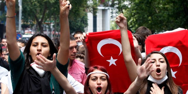 Protesters shout anti-government slogans during a demonstration in Ankara June 3, 2013. Turkish Prime Minister Tayyip Erdogan accused anti-government protesters on Monday of walking "arm-in-arm with terrorism", remarks that could further inflame public anger after three days of some of the most violent riots in decades.