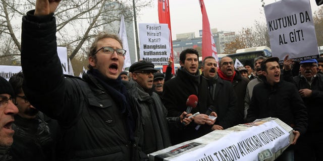 Dec. 21, 2013: People shout anti-government slogans as they carry a casket made of empty shoe boxes during a protest in Ankara, Turkey.