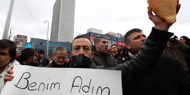 March 11, 2014: People gather to protest the death of Berkin Elvan, a Turkish teenager who was in a coma since being hit on the head by a tear gas canister fired by police during the last summer's anti-government protests, in Ankara, Turkey.