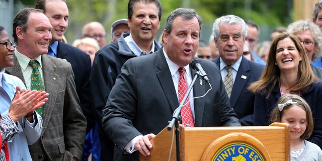 May 17, 2016: As First Lady Mary Pat Christie, right, and others laugh, New Jersey Governor Chris Christie addresses a gathering at the opening of the new African Adventure Exhibit at the Turtle Back Zoo in West Orange, N.J.