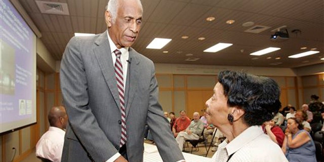 Aug. 1, 2007: In this photo, Milton Crenchaw, who was a member of the first all-black unit in the Army Air Corps during World War II known as the Tuskegee Airmen, left, speaks with Thessia Dunn before participating in a lecture series at the Butler Center for Arkansas Studies in Little Rock, Ark.