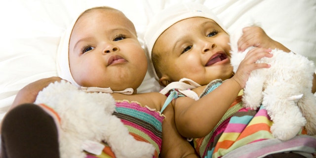 Sisters Ritag (L) and Rital Gaboura are seen together on a bed after an operation to separate them, in this undated photograph received in London on September 18, 2011. Surgeons at a British hospital have successfully separated conjoined twin baby girls in a complex and extremely rare operation, the charity that funded the surgery said on Sunday. Sudan-born Rital and Ritag Gaboura are craniopagus twins, meaning they were born joined at the head. REUTERS/Facing the World/Handout