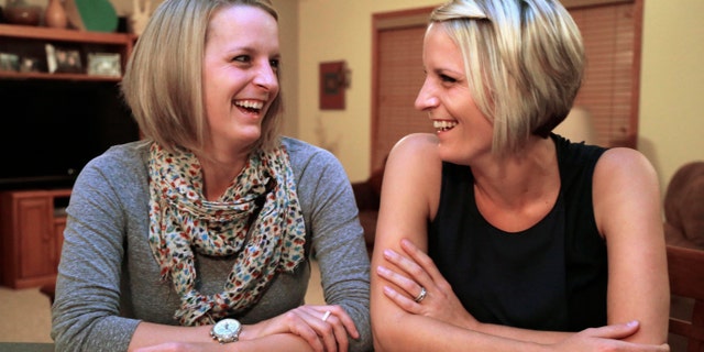 Identical twins Kristen Maurer, left, and Kelly McCarthy. (AP Photo/M. Spencer Green)