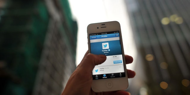 LONDON, ENGLAND - NOVEMBER 07: In this photo illustration, The Twitter logo is displayed on a mobile device as the company announced it's initial public offering and debut on the New York Stock Exchange on November 7, 2013 in London, England. Twitter went public on the NYSE opening at USD 26 per share, valuing the company's worth at an estimated USD 18 billion. (Photo by Bethany Clarke/Getty Images)