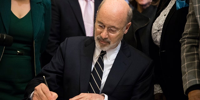 Pennsylvania Gov. Tom Wolf vetoes a bill passed by the Republican-controlled Legislature to limit abortions to the first 20 weeks of pregnancy at City Hall in Philadelphia, Monday, Dec. 18, 2017.