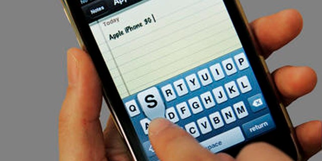 A customer uses an Apple iPhone 3GS at an Apple store in Palo Alto, Calif., Tuesday, July 21, 2009. (AP Photo/Paul Sakuma)