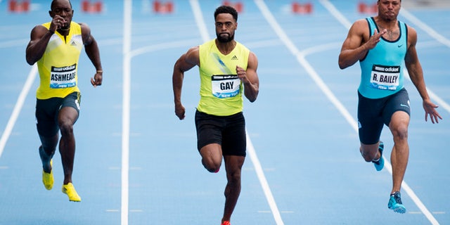 In a May 25, 2013, file photo Tyson Gay, center, competes in the Men's 100m alongside Ryan Bailey, right, and Nickel Ashmeade, of Jamaica, during the IAAF Diamond League Grand Prix competition in New York. Gay was informed Friday July 12, 2013, he has tested positive for a banned substance and says he will pull out of the world championships next month in Moscow.