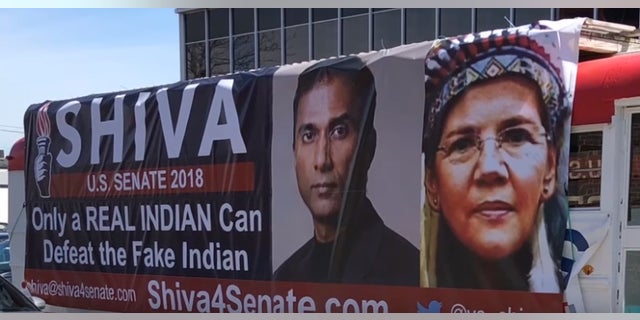 A bus parked outside Shiva Ayyadurai's campaign headquarters taunts Mass. Democratic Sen. Elizabeth Warren's claims of Native American heritage.