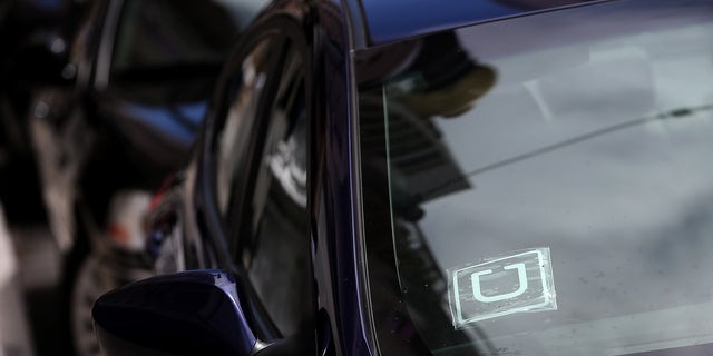 SAN FRANCISCO, CA - JUNE 12: A sticker with the Uber logo is displayed in the window of a car on June 12, 2014 in San Francisco, California. The California Public Utilities Commission is cracking down on ride sharing companies like Lyft, Uber and Sidecar by issuing a warning that they could lose their ability to operate within the state if they are caught dropping off or picking up passengers at airports in California. (Photo by Justin Sullivan/Getty Images)