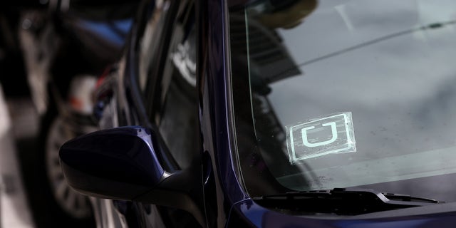 SAN FRANCISCO, CA - JUNE 12: A sticker with the Uber logo is displayed in the window of a car on June 12, 2014 in San Francisco, California. The California Public Utilities Commission is cracking down on ride sharing companies like Lyft, Uber and Sidecar by issuing a warning that they could lose their ability to operate within the state if they are caught dropping off or picking up passengers at airports in California. (Photo by Justin Sullivan/Getty Images)