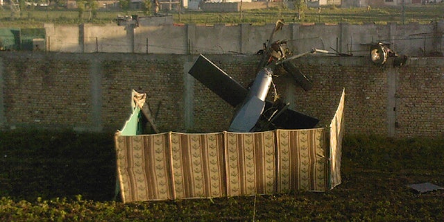 May 2: A photo taken by a local resident shows the wreckage of a helicopter next to the wall of the compound where, according to officials, Osama bin Laden was shot and killed in a firefight with U.S. forces in Abbottabad, Pakistan. Bin Laden, the glowering mastermind behind the Sept. 11, 2001, terror attacks that killed thousands of Americans, was slain in his luxury hideout in Pakistan early Monday. (AP/Mohammad Zubair)