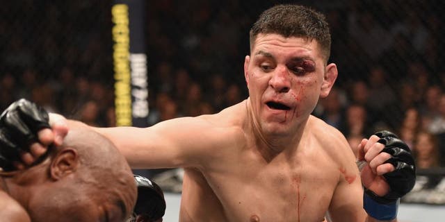LAS VEGAS, NV - JANUARY 31: (R-L) Nick Diaz punches Anderson Silva of Brazil in their middleweight bout during the UFC 183 event at the MGM Grand Garden Arena on January 31, 2015 in Las Vegas, Nevada. (Photo by Josh Hedges/Zuffa LLC/Zuffa LLC via Getty Images)