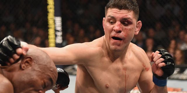 LAS VEGAS, NV - JANUARY 31: (R-L) Nick Diaz punches Anderson Silva of Brazil in their middleweight bout during the UFC 183 event at the MGM Grand Garden Arena on January 31, 2015 in Las Vegas, Nevada. (Photo by Josh Hedges/Zuffa LLC/Zuffa LLC via Getty Images)