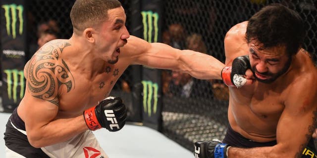 LAS VEGAS, NV - APRIL 23: (L-R) Robert Whittaker of New Zealand punches Rafael Natal in their middleweight bout during the UFC 197 event inside MGM Grand Garden Arena on April 23, 2016 in Las Vegas, Nevada. (Photo by Josh Hedges/Zuffa LLC/Zuffa LLC via Getty Images)