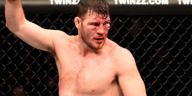 MANCHESTER, ENGLAND - OCTOBER 08: Michael Bisping of England raises his hand after facing Dan Henderson in their UFC middleweight championship bout during the UFC 204 Fight Night at the Manchester Evening News Arena on October 8, 2016 in Manchester, England. (Photo by Josh Hedges/Zuffa LLC/Zuffa LLC via Getty Images)