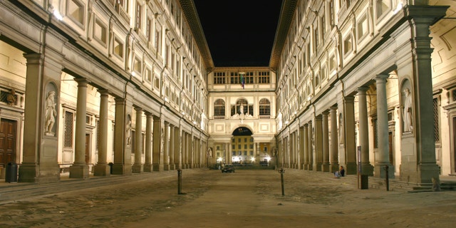 The Uffizi museum in Florence, Italy, by night. Faces blurred by long exposure.