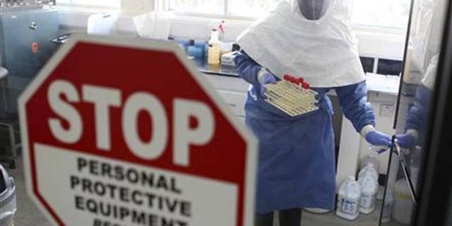 A doctor works in a laboratory on collected samples of the Ebola virus at the Centre for Disease Control in Entebbe, about 37 km (23 miles) southwest of Uganda's capital Kampala, August 2, 2012. REUTERS/Edward Echwalu