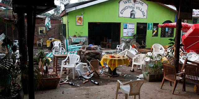 Damaged chairs and tables are seen among the debris strewn outside the restaurant "Ethiopian village" in Kampala, Uganda, July 12 after an explosion at the restaurant late Sunday. (AP Photo)