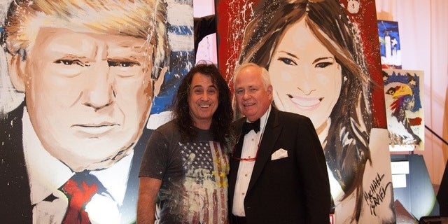 Artist Michael Israel poses with Timothy Lane, the man who bidded the highest for the paintings of President Trump and first lady Melania Trump.