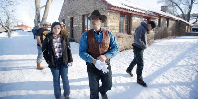 JANUARY 2016: Ryan Bundy, center, one of the sons of Nevada rancher Cliven Bundy, walks through the Malheur National Wildlife Refuge near Burns, Ore. I