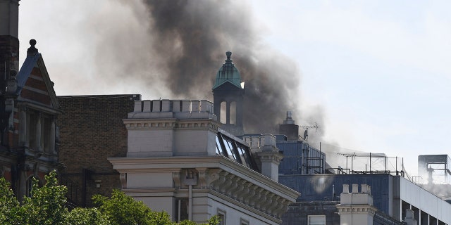Smoke rises from a building in Knightsbridge, central London, as London Fire Brigade responded to a call of a fire in this upmarket location.