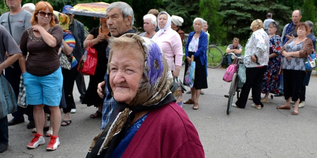 June 23, 2014: Local citizens lineup to get free food in besieged Slovyansk, eastern Ukraine. Insurgents promised Monday to honor a cease-fire declared by the Ukrainian president and engage in more talks to help resolve the conflict that has left hundreds dead in eastern Ukraine.