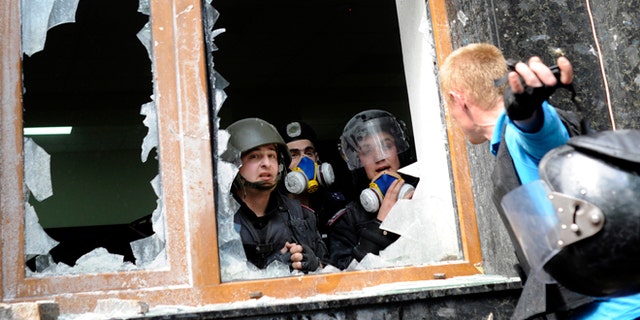 May 1, 2014: A Pro-Russian activist, right, speaks with police officers during clashes in front of the regional administration building in Donetsk, Ukraine. Anti-government demonstrators in Donetsk have stormed the local prosecutor's office. The clash came after a march by several hundred people carrying flags of the Donetsk People's Republic, a movement that seeks either greater autonomy from the central government, or independence and possible annexation by Russia.