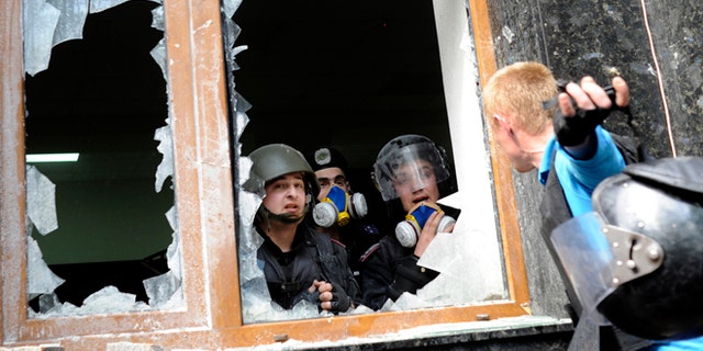 May 1, 2014: A Pro-Russian activist, right, speaks with police officers during clashes in front of the regional administration building in Donetsk, Ukraine. Anti-government demonstrators in Donetsk have stormed the local prosecutor's office. The clash came after a march by several hundred people carrying flags of the Donetsk People's Republic, a movement that seeks either greater autonomy from the central government, or independence and possible annexation by Russia.