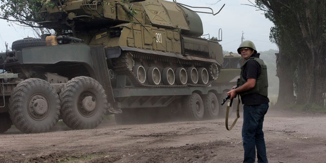 July 4, 2014: Ukrainian government forces maneuver antiaircraft missile launchers Buk as they are transported north-west from Slavyansk, eastern Ukraine.