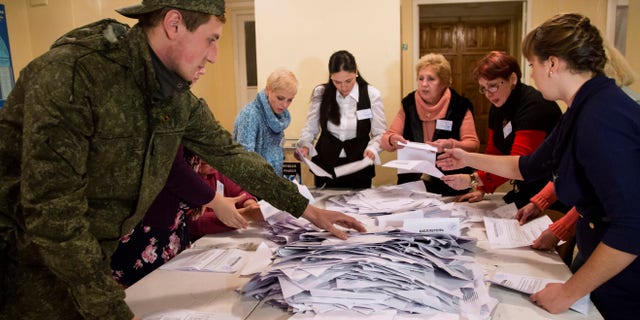 Nov. 2, 2014: Election officials count the votes during rebel elections at a polling station in the city of Donetsk, eastern Ukraine