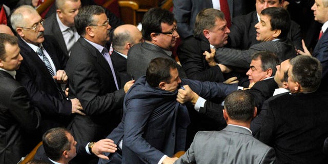 Dec. 13, 2012: Ukrainian lawmakers fight around the rostrum during the first session of Ukraine's newly elected parliament in Kiev, Ukraine.