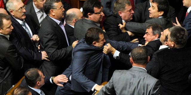 Dec. 13, 2012: Ukrainian lawmakers fight around the rostrum during the first session of Ukraine's newly elected parliament in Kiev, Ukraine.
