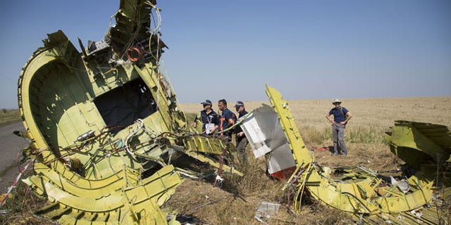 Aug 1, 2014: Australian and Dutch investigators examine pieces of the Malaysia Airlines Flight 17 plane, near the village of Hrabove, Donetsk region, eastern Ukraine.