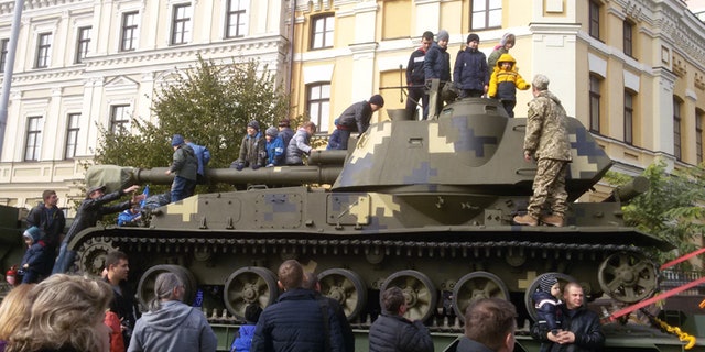 Children climbed atop military vehicles as President Poroshenko vowed that Ukraine would defend itself against all threats. (FoxNews.com)