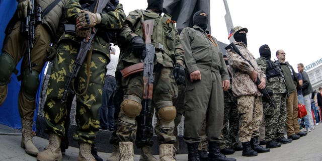 June 21, 2014: Pro-Russian fighters stand guard in Donetsk, eastern Ukraine.