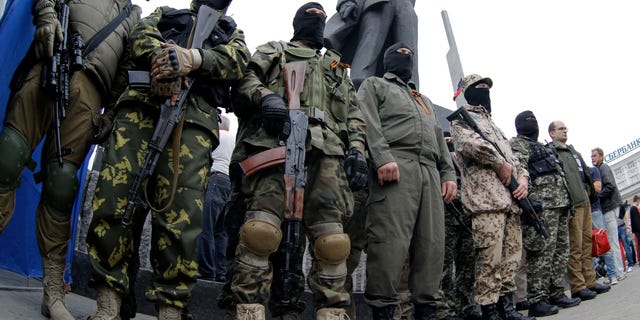 June 21, 2014: Pro-Russian fighters stand guard in Donetsk, eastern Ukraine.