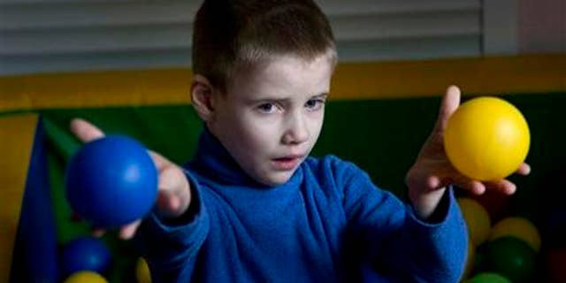 April 14, 2015: In this photo, blind five-year old boy, Lev plays during an art class in the Center for Children with Disabilities, Rodyna, (Family) in Kiev, Ukraine.