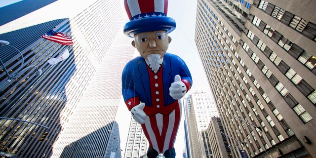 Nov. 28, 2013: An Uncle Sam balloon floats down Sixth Avenue during the 87th Macy's Thanksgiving Day Parade.