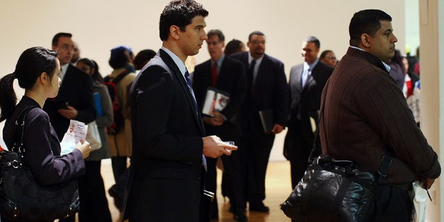 NEW YORK - APRIL 02: People wait on line to speak with job recruiters on at the New York City Career Fair April 2, 2009 in New York City. Hundreds of people dropped off resumes, attended seminars and spoke with employers from a broad selection of careers in the hope of gaining employment. As the global economic downturn continues, the U.S. rate of unemployment rose from 7.6 percent in January to 8.1 percent in February while newly released U.S. claims for state unemployment benefits jumped last week to a 26-year high. (Photo by Spencer Platt/Getty Images)
