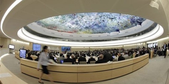A woman walks past the Human Rights Council at the European headquarters of the United Nations in Geneva May 31. (AP Photo)