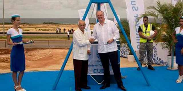 Unilever CEO Paul Polman, right, and Cuba's Minister of Industries Salvador Pardo, pose for photos after laying a cornerstone for a new business center, in Mariel, Cuba, Friday, Nov. 4, 2016. The Dutch consumer product giant has become one of the largest foreign companies to move into a special economic development zone at the Cuban port of Mariel that is meant to jumpstart outside investment on the island. (Ismael Francisco/Cubadebate via AP)