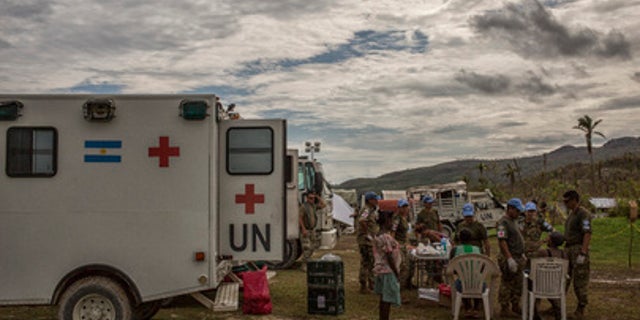 Argentinian peacekeepers with the United Nations Mission in Haiti (MINUSTAH) administer medical aid to residents of Les Cayes affected by Hurricane Matthew.